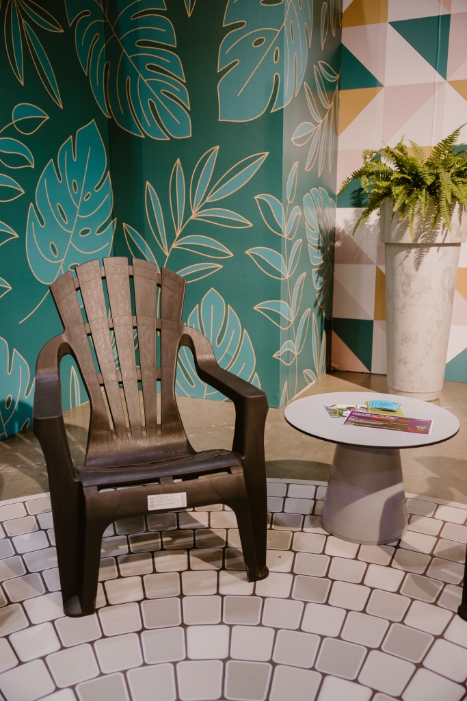 A black Muskoka chair with a grey coffee table next to it