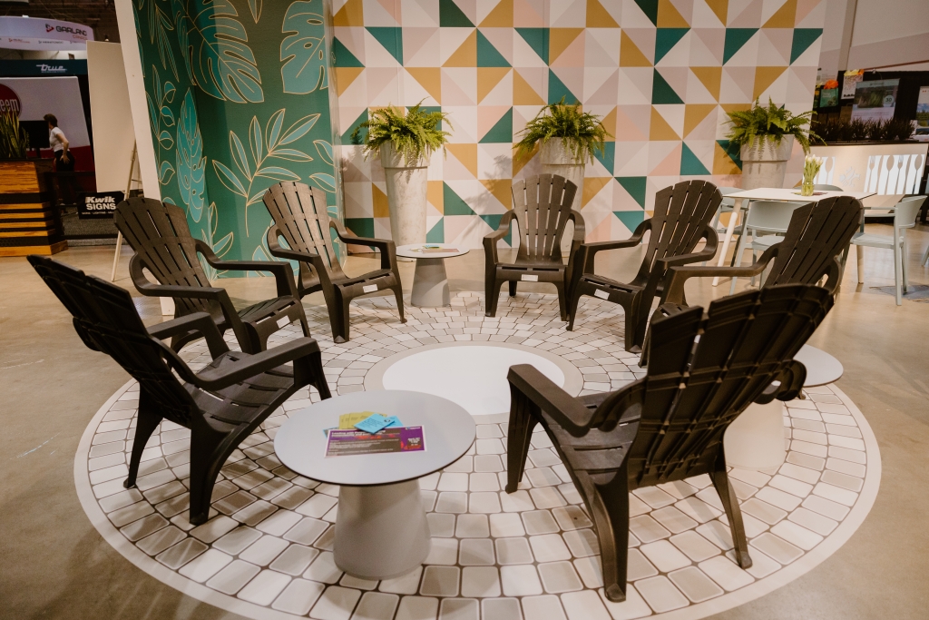 Black Muskoka chairs arranged in a circle with some grey coffee tables in between them