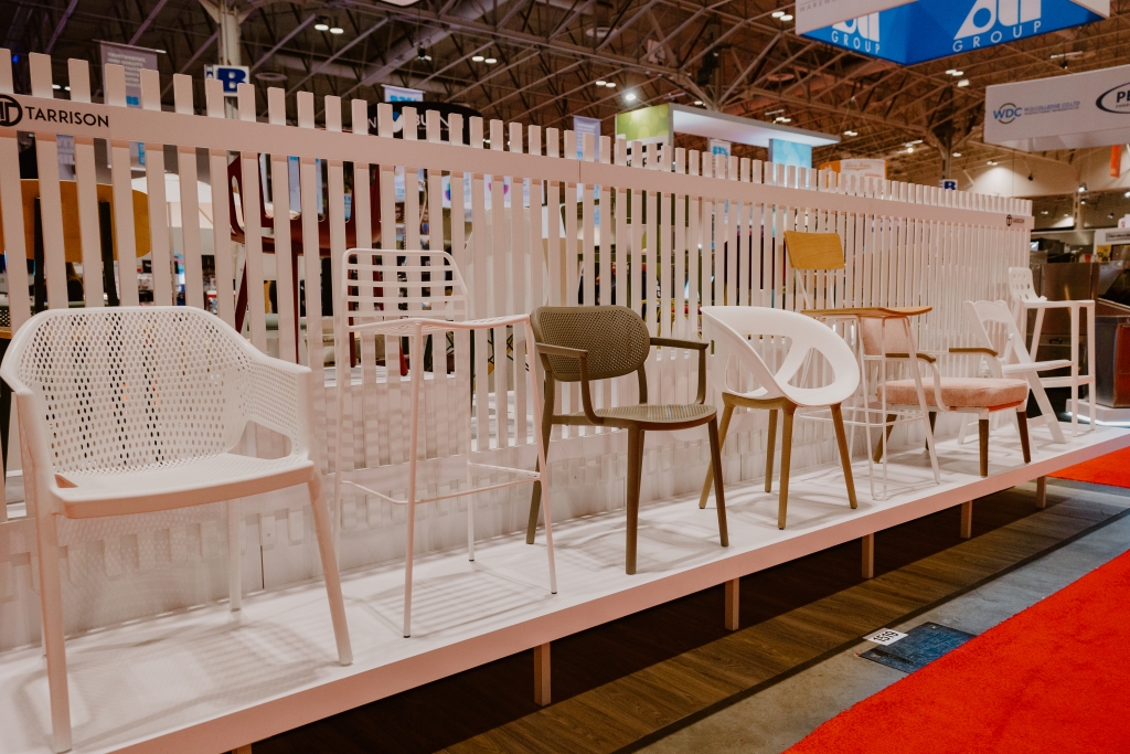 A tradeshow booth with different styles of chairs on display
