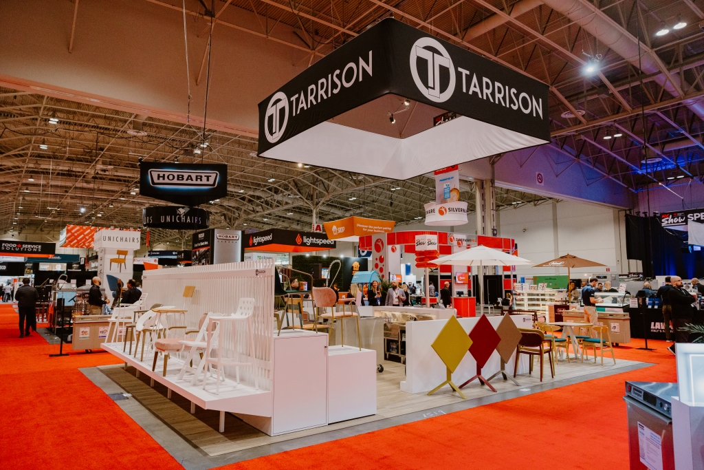 Tarrison's tradeshow booth displaying different styles of contract-grade furniture and stainless steel equipment