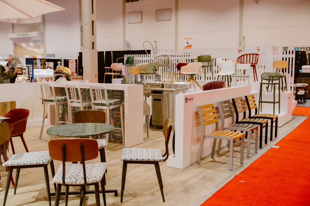 A tradeshow booth with different styles of chairs on display
